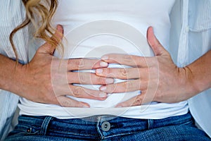 woman clutching her stomach in discomfort