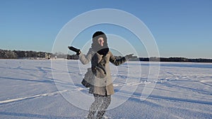 Woman coat gloves throw fluffy friable snow wind fun winter