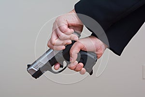 Woman cocking a hand gun