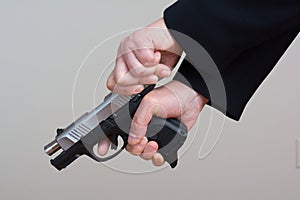 Woman cocking a hand gun