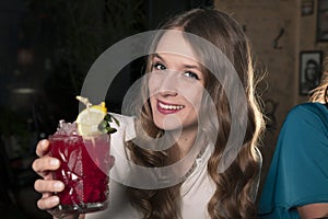 Woman with cocktail in a bar