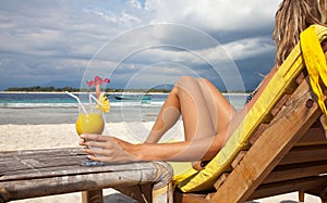 Woman with a cocktail on beach