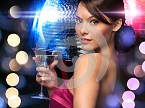 Woman with cocktail and disco ball