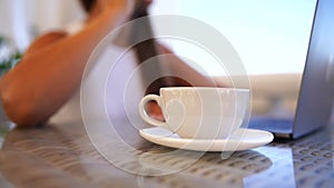 Woman coffee cafe macbook. Woman sitting at a coffee shop with mobile phone drinking coffee and looking away. Caucasian