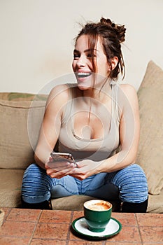 Woman with Coffee cup on ceramic table and mobile phone