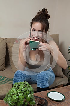 Woman with Coffee cup on ceramic table and mobile phone