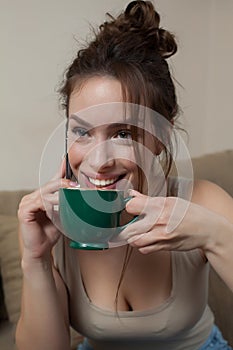 Woman with Coffee cup on ceramic table and mobile phone