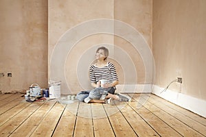 Woman With Coffee Mug Sitting On Floorboard