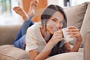 Woman, coffee and portrait on sofa for relax weekend in apartment for calm holiday, peaceful or vacation. Female person