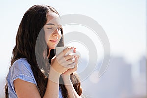 Woman, coffee and relax outdoor for calm freedom, peace summer vacation or travel holiday with closed eyes. Sunshine