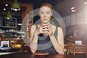 Woman, coffee shop and calm portrait with latte and happy customer with smile and table. Cup, restaurant and relax