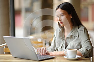 Woman in a coffee shop using laptop