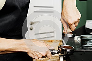 Woman coffee shop worker preparing coffee on professional coffee machine