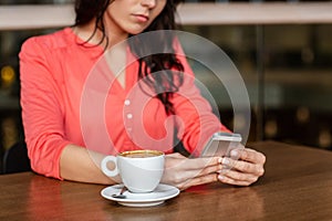 woman with coffee and smartphone at restaurant