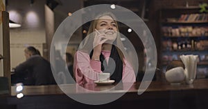 Woman with coffee talking on smartphone