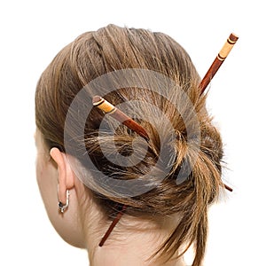 Woman coiffure with asian sticks photo