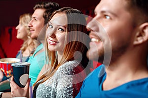 Woman with coke in cinema between viewer