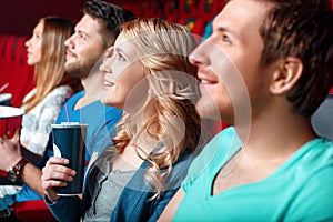 Woman with coke in cinema between viewer