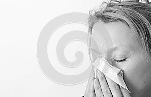 Woman with a cold blowing nose stock photo