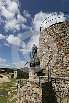 Woman with cold covered with a blanket climbing a ladder of a tower in winter, rear view photo