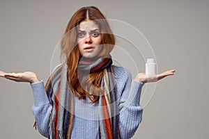 woman cold taking medication light background