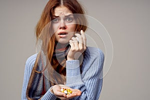 woman cold taking medication light background