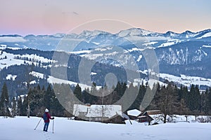 Woman in Cold winter landscape in evening light in the Allgaeu Alps