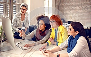 Woman with colleagues working on computer