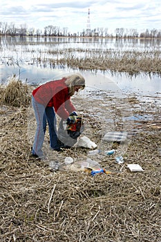 Woman collecting rubbish in nature