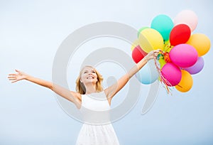 Woman with colorful balloons outside