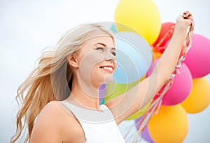 Woman with colorful balloons outside