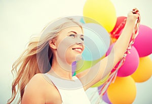 Woman with colorful balloons outside