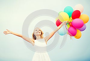 Woman with colorful balloons outside