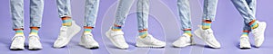 Woman in colorful socks, white sneakers and jeans on violet background, closeup. Collection of photos