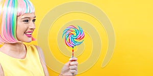 Woman in a colorful wig with a lollipop