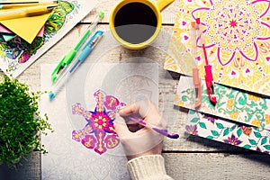 Woman coloring an adult coloring book, new stress relieving trend