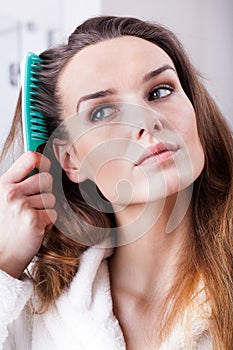 Woman combing hair