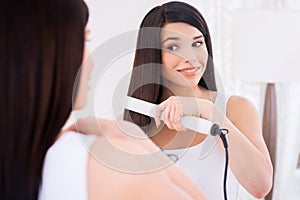 Woman combing hair.