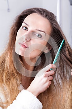 Woman combing hair