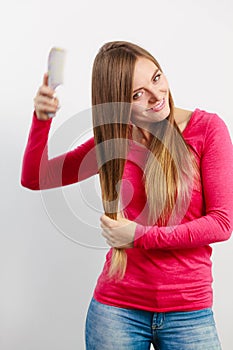 Woman combing her hair.