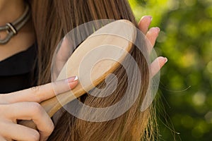 Woman combing her hair in the park