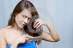 Woman combing her long hair