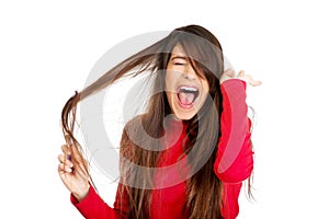 Woman combing her tangled hair.