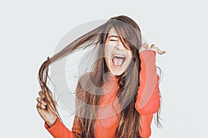 Woman combing her tangled hair.