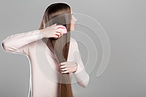 Woman combing long natural hair