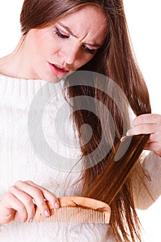 Woman combing and pulls hair