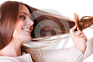Woman combing and pulls hair.