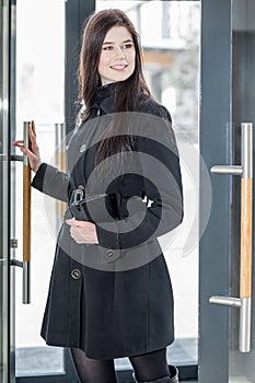 Woman comes through the glass door photo
