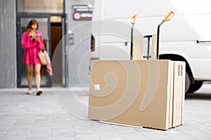 Woman comes out of the entrance to pick up parcels