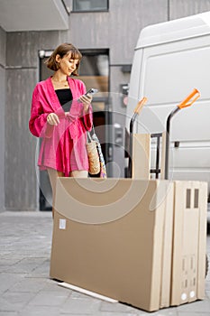 Woman comes out of the entrance to pick up parcels